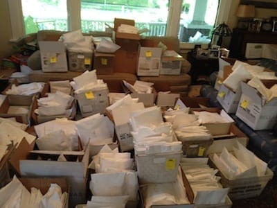 My living room: packages awaiting postage and labels, while I awaited a replacement printer that wouldn't break after printing a mere 150 labels like the first one did. Silly me: Printer #2 ended up breaking at least four times. Cyndie fixed the first times, then I tackled it solo. Then, six (6!!) shirts from the end, it seemed to break for good. Deep breath.