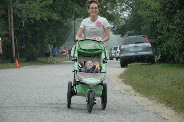 Woman running with jogging stroller