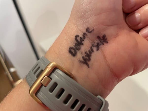 "Define yourself" written on a wrist, choosing adversity
