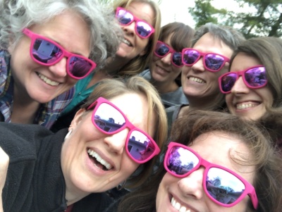 Seven women in pink sunglasses