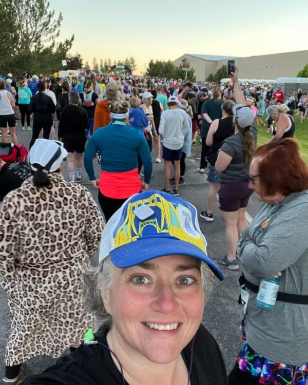 Middle aged lady in a hat at the start of the Missoula Half Marathon