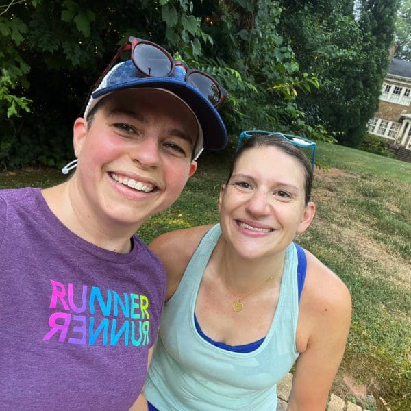 Two smiling women wearing running clothes